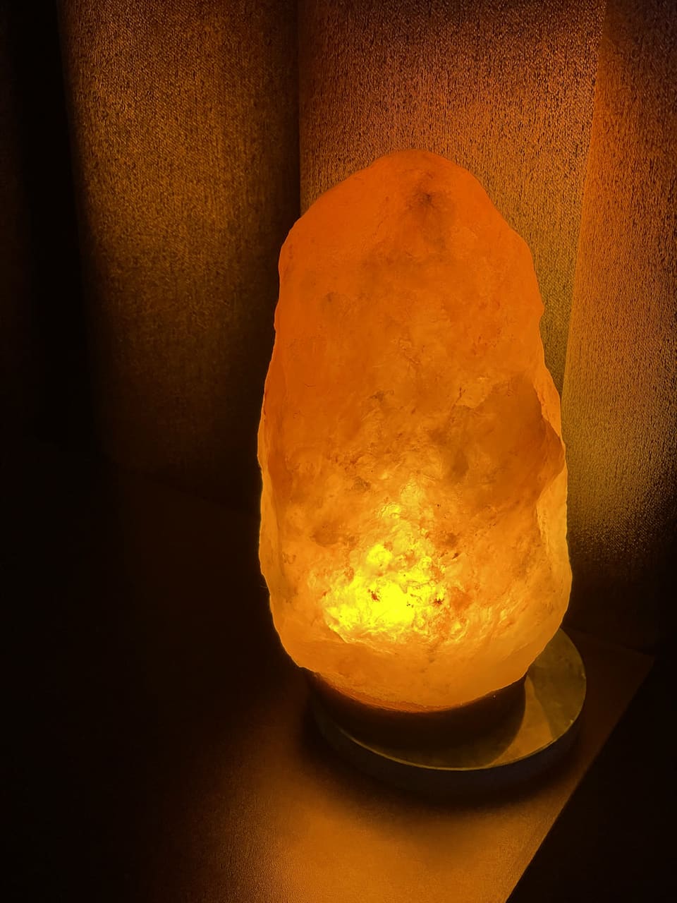 A warm Himalayan salt lamp glowing in the studio